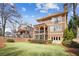 Spacious backyard with lush lawn and mature trees, showcasing the home's exterior at 1211 Thornwell Ne Dr, Brookhaven, GA 30319