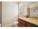 Well-lit bathroom featuring granite countertop, custom cabinets, and decorative tile shower at 1211 Thornwell Ne Dr, Brookhaven, GA 30319