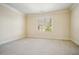 Bright and airy bedroom with a large window providing ample natural light and neutral carpet at 1211 Thornwell Ne Dr, Brookhaven, GA 30319
