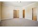 Spacious bedroom with neutral carpet, crown molding, and access to walk-in closet and ensuite bathroom at 1211 Thornwell Ne Dr, Brookhaven, GA 30319