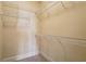 Walk-in closet with multiple tiers of shelving and carpet floors at 1211 Thornwell Ne Dr, Brookhaven, GA 30319
