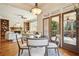 Dining area with view of the open living room and doors that open to an outdoor living space at 1211 Thornwell Ne Dr, Brookhaven, GA 30319