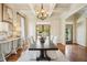 Refined dining room featuring a large table with seating, chandelier lighting, and elegant decor for formal meals at 1211 Thornwell Ne Dr, Brookhaven, GA 30319