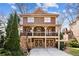 Charming two-story home with a welcoming front porch and two-car garage, showcasing classic architectural details at 1211 Thornwell Ne Dr, Brookhaven, GA 30319