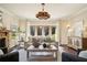 Inviting living room with hardwood floors, stone fireplace, modern furnishings, and natural light at 1211 Thornwell Ne Dr, Brookhaven, GA 30319