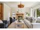 Cozy living room featuring a stone fireplace, hardwood floors, and ample seating at 1211 Thornwell Ne Dr, Brookhaven, GA 30319
