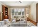 Living room featuring a large window, comfortable seating, and hardwood floors, perfect for relaxation at 1211 Thornwell Ne Dr, Brookhaven, GA 30319