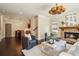 Stylish living room featuring a stone fireplace, hardwood floors, and comfortable seating at 1211 Thornwell Ne Dr, Brookhaven, GA 30319