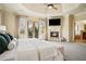 Bedroom featuring a fireplace, TV, and double doors to balcony at 1211 Thornwell Ne Dr, Brookhaven, GA 30319