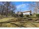 Residential backyard featuring a home exterior and a well-manicured lawn area at 133 Hickory Trl, Cumming, GA 30040
