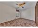 Simple bedroom features carpet, a ceiling fan, and a window bringing in natural light at 133 Hickory Trl, Cumming, GA 30040