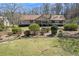 Quaint single-story home with mature landscaping and a well-maintained front lawn at 133 Hickory Trl, Cumming, GA 30040
