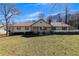 Charming single-story home featuring a welcoming front porch and manicured lawn at 133 Hickory Trl, Cumming, GA 30040