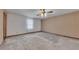 Spacious primary bedroom with carpet, wallpaper accent wall, and window for natural light at 133 Hickory Trl, Cumming, GA 30040