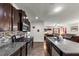 Open-concept kitchen with island bar and granite counter overlooks living room at 1332 Worcester Trl, Mcdonough, GA 30253