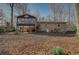 A multi-level brick house with an elevated porch and a very generous sloping backyard filled with mature trees at 2870 Carla Nw Dr, Kennesaw, GA 30144