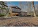 Spacious backyard featuring a covered patio and a multi-level brick home with ample windows at 2870 Carla Nw Dr, Kennesaw, GA 30144
