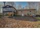 A multi-level brick home has an elevated porch, and a generous backyard sloping away from the foundation at 2870 Carla Nw Dr, Kennesaw, GA 30144