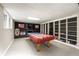 Basement game area with a pool table, fireplace, and custom shelving at 2870 Carla Nw Dr, Kennesaw, GA 30144