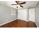 Bedroom features hardwood floors, two closets, and a ceiling fan at 2870 Carla Nw Dr, Kennesaw, GA 30144
