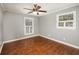 A bedroom with hardwood floors, gray-toned walls, and two windows to let in natural light at 2870 Carla Nw Dr, Kennesaw, GA 30144
