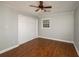 This bedroom has wood floors, a closet, a window, and a ceiling fan at 2870 Carla Nw Dr, Kennesaw, GA 30144