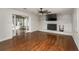 Spacious living room with hardwood floors, fireplace, and sliding doors leading to a sunroom at 2870 Carla Nw Dr, Kennesaw, GA 30144