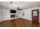 Cozy living room showcases hardwood floors, a painted brick fireplace, and a stylish entry door at 2870 Carla Nw Dr, Kennesaw, GA 30144