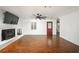 Well-lit living room featuring hardwood floors, brick fireplace, and seamless access to the kitchen at 2870 Carla Nw Dr, Kennesaw, GA 30144