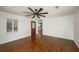 Open-concept living area with rich hardwood floors, a bright window, and convenient kitchen access at 2870 Carla Nw Dr, Kennesaw, GA 30144