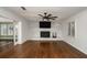 Bright living room featuring a painted brick fireplace, hardwood floors, and a ceiling fan at 2870 Carla Nw Dr, Kennesaw, GA 30144