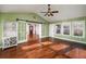 Bright sunroom features hardwood floors, multiple windows, and barn doors leading to other rooms at 2870 Carla Nw Dr, Kennesaw, GA 30144