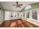 Sunroom features hardwood floors, multiple windows, vaulted ceilings, and a ceiling fan at 2870 Carla Nw Dr, Kennesaw, GA 30144
