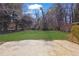 Lush backyard with mature trees and a spacious concrete patio area at 2911 Botany Dr, Jonesboro, GA 30236