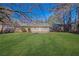 Well-maintained lawn in the backyard, leading up to the house and outbuilding at 2911 Botany Dr, Jonesboro, GA 30236