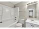 Bright bathroom showcasing a shower-tub combo, vanity with storage, and modern fixtures at 2911 Botany Dr, Jonesboro, GA 30236