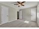 Spacious bedroom with neutral carpeting, two closets, and a ceiling fan at 2911 Botany Dr, Jonesboro, GA 30236