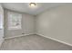 Cozy bedroom featuring neutral walls, comfortable carpeting, and a window offering natural light at 2911 Botany Dr, Jonesboro, GA 30236