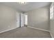 Calm bedroom showcasing neutral carpeting, generous natural light, and closet with easy access at 2911 Botany Dr, Jonesboro, GA 30236