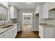 Bright kitchen featuring white cabinets, granite countertops, and wood-look flooring at 2911 Botany Dr, Jonesboro, GA 30236