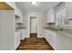 Bright kitchen featuring white cabinets, granite countertops, and wood-look flooring at 2911 Botany Dr, Jonesboro, GA 30236