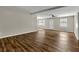 Bright living room featuring wood-look flooring, neutral paint, ceiling fan, and ample natural light at 2911 Botany Dr, Jonesboro, GA 30236