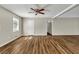 Inviting living room with new flooring, large windows, and a modern ceiling fan at 2911 Botany Dr, Jonesboro, GA 30236