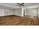 Open living space featuring wood-look floors, neutral walls, ceiling fan, and a dining area at 2911 Botany Dr, Jonesboro, GA 30236