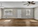 Spacious living room with wood floors, neutral walls, large windows and contemporary ceiling fan at 2911 Botany Dr, Jonesboro, GA 30236