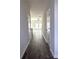 Hallway featuring hard surface floors with a view to living area at 5432 Plain Field Ln, Lilburn, GA 30047