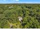 Aerial view of a home nestled in a mature forest, showcasing the surrounding landscape and city skyline at 1893 Burning Tree Dr, Decatur, GA 30032