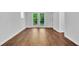 A newly renovated basement featuring wood floors and bright French doors to the outside at 1893 Burning Tree Dr, Decatur, GA 30032