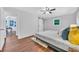 Bedroom features hardwood floors, ceiling fan, closet with sliding barn door and modern decor at 1893 Burning Tree Dr, Decatur, GA 30032