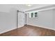 Bedroom features wood floors, window view, and a sliding barn door with closet at 1893 Burning Tree Dr, Decatur, GA 30032